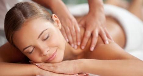 smiling woman having neck massage at home