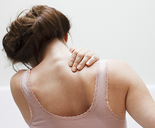 woman with pain in neck and shoulders