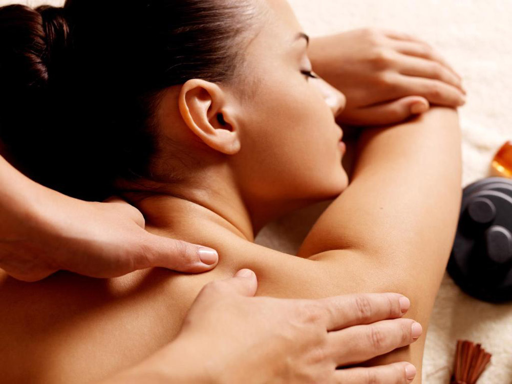 Close-up of a client receiving a mobile Swedish massage in York, with the therapist applying targeted pressure to the shoulder and upper back to relieve muscle tension.