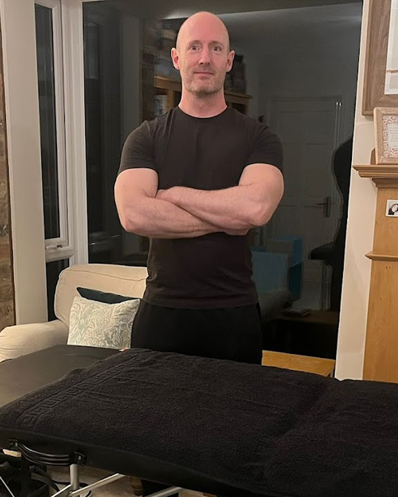 David Hields, mobile massage therapist and advanced personal trainer in York, pictured with a professional massage table.